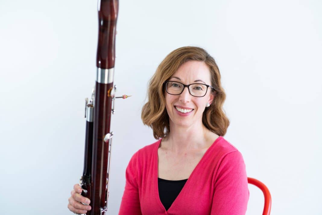 smiling female musician with oboe
