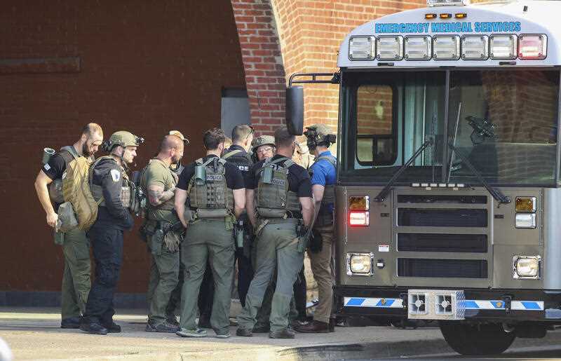 Multiple agencies arrive at a building after a shooting took place in Louisville, Ky., Monday, April 10, 2023